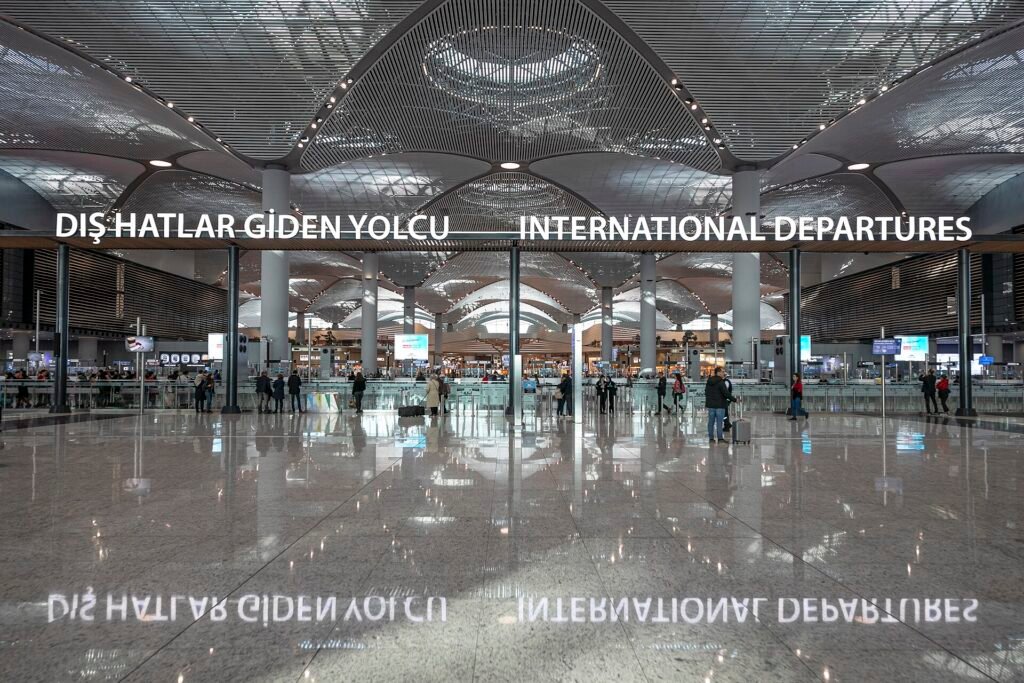 Ruime vertrekhal van Istanbul Airport met reizigers en incheckbalies